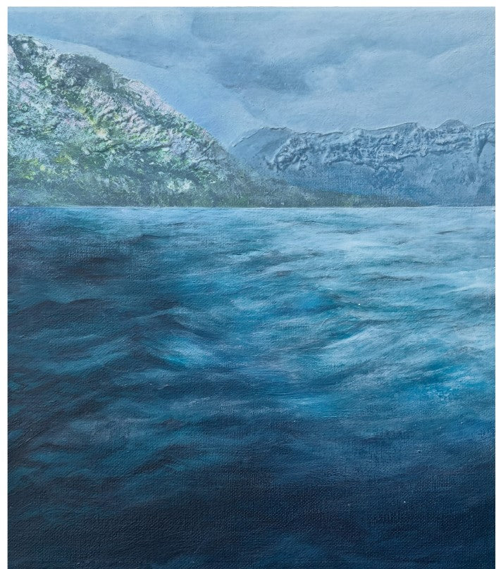 A landscape painting depicting a vast, textured blue sea in the foreground with rugged mountains covered in patches of snow under a cloudy, overcast sky.